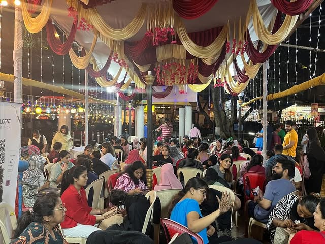 A packed Mehandi Mela under red and gold drapes in 2024